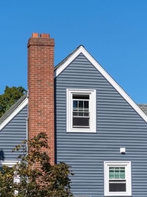 Home,Facade,With,Gable,Roof,,Blue,Siding,And,Brick,Chimney